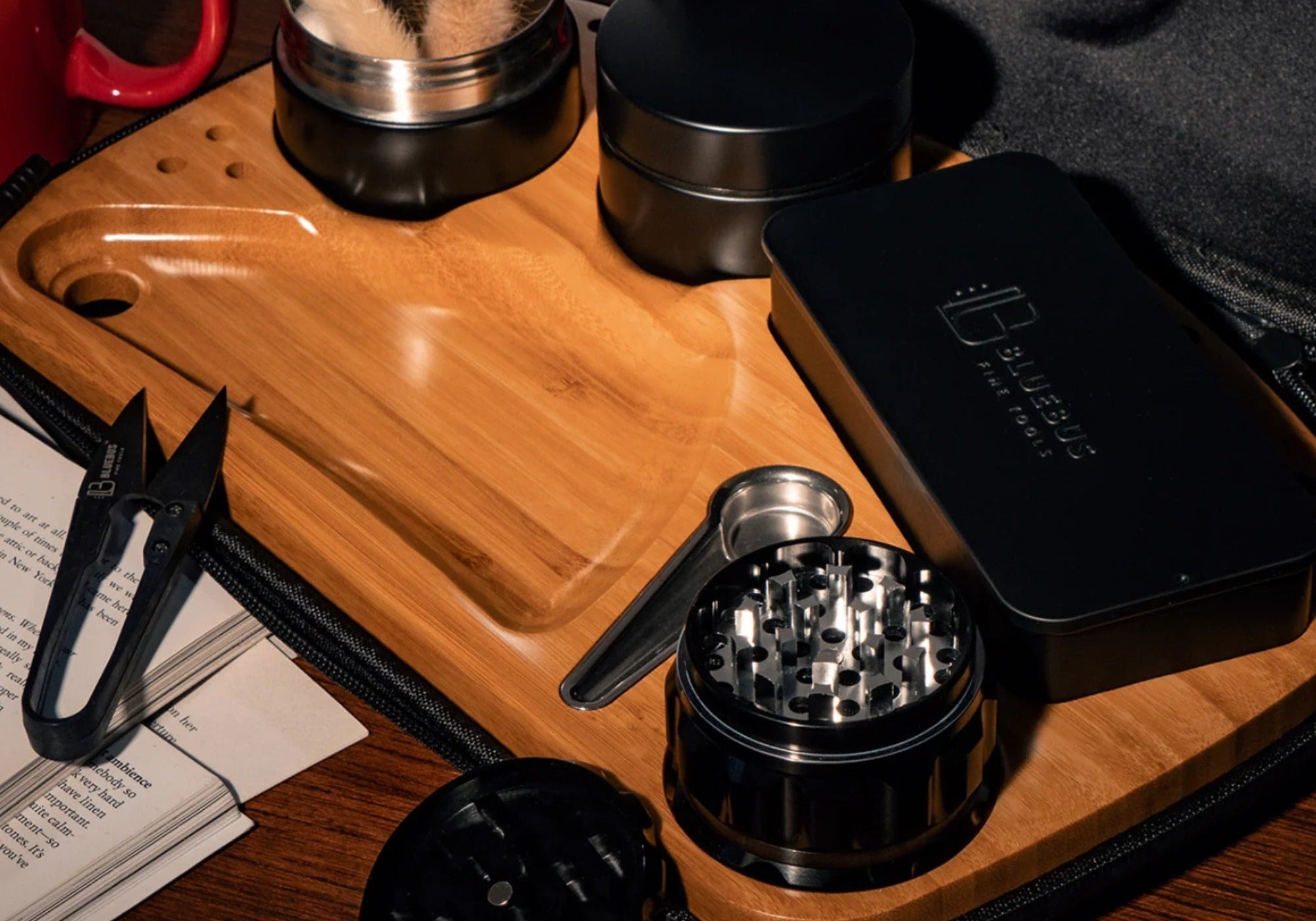 BLAZE Wooden Rolling Tray in bamboo with grinder, jars, tin case and mini scissors on a table