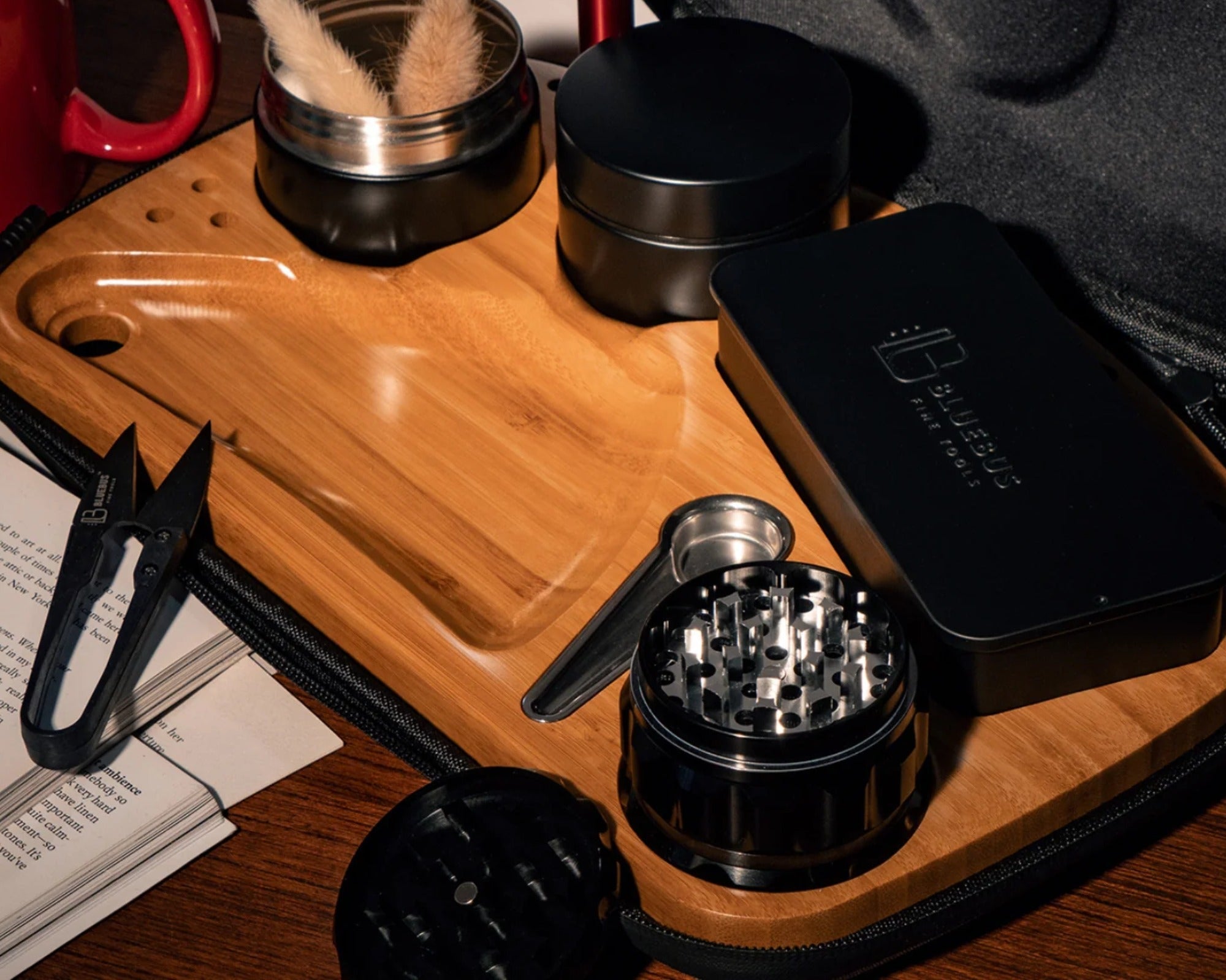 BLAZE Wooden Rolling Tray in bamboo with grinder, jars, tin case and mini scissors on a table